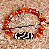Carnelian and agate beaded stretch bracelet, 'Orange Fate' - Carnelian and Agate Beaded Dzi Pendant Bracelet in Orange