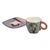 Ceramic cup and saucer, 'Urban Elixir' - Hand-Painted Naïf Urbanscape-Themed Ceramic Cup and Saucer