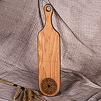 Wood trivet, 'Regal Flavors' - Hand-Carved Leafy Oblong-Shaped Beechwood Trivet with Handle