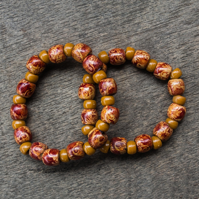 Wood stretch bracelets, 'African Grace' (pair) - 2 Red and Brown Floral Beaded Wood Stretch Bracelets
