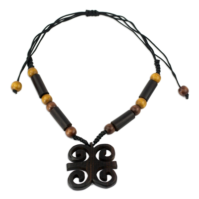 Ebony wood pendant necklace, 'Ram's Horns' - African Ebony and Sese Wood Ram's Horn Adinkra Necklace