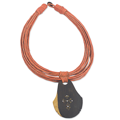 Ebony wood pendant necklace, 'Zacksongo in Orange' - Ebony Wood Pendant Necklace with Orange Leather Cord