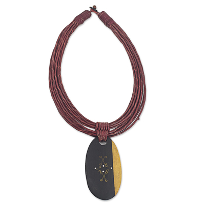 Ebony wood pendant necklace, 'Zacksongo in Wine' - Ebony Wood Pendant Necklace with Wine Leather Cord