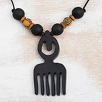 Wood pendant necklace, 'Duafe Comb' - Artisan Crafted Adinkra Wood Necklace with Duafe Comb Symbol