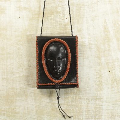 Leather cell phone shoulder bag, 'Watcher' - Black Leather Cell Phone Shoulder Bag with a Face from Ghana