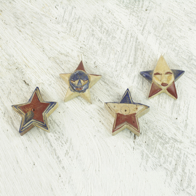 Wood ornaments, 'Nsruma Pride' (set of 4) - Four Sese Wood Star Ornaments in Red Blue and Beige