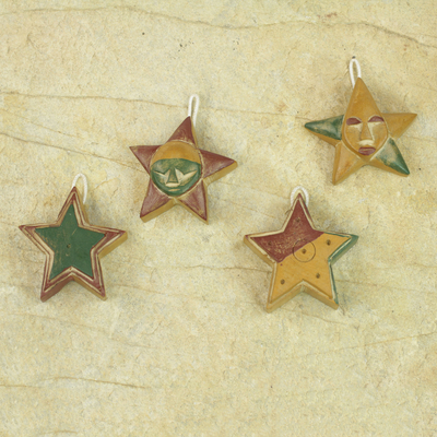 Wood ornaments, 'Nsruma Glory' (set of 4) - Four Sese Wood Star Ornaments in Red Green and Yellow