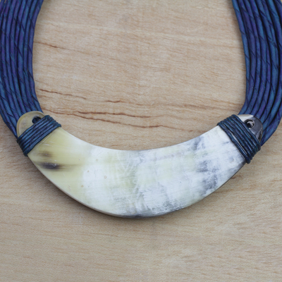 Horn pendant necklace, 'Sida' - Crescent-Shaped Horn Pendant Necklace with Blue Leather Cord