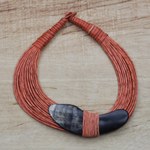 Horn pendant necklace, 'Tuumsongo' - Boomerang Horn Pendant Orange Leather Cord Necklace