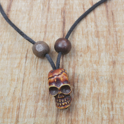 Wood and recycled plastic pendant necklace, 'Amazing Skull' - Wood and Recycled Plastic Skull Necklace from Ghana