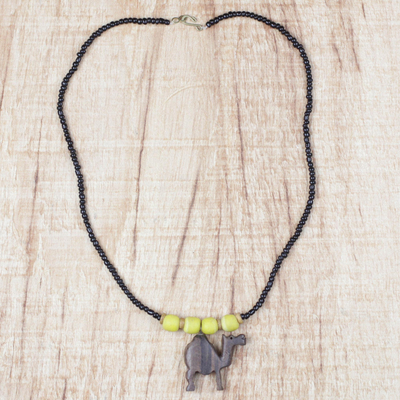 Ebony wood and recycled glass beaded pendant necklace, 'On Dry Land' - Ebony Wood and Glass Camel Pendant Necklace from Ghana