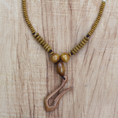 Wood beaded pendant necklace, 'Odo Ye De' - Sese Wood Beaded Pendant Necklace Handcrafted in Ghana