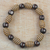 Wood and recycled plastic beaded stretch bracelet, 'Good Spirals' - Spiral Motif Wood and Plastic Stretch Bracelet from Ghana thumbail