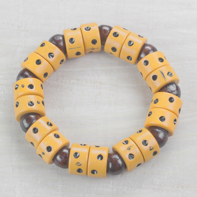 Wood and recycled plastic beaded stretch bracelet, 'Apple of Meniwa' - Dot Motif Wood and Plastic Stretch Bracelet from Ghana