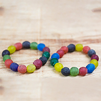 Recycled glass beaded stretch bracelets, 'Festive Sensation' (pair) - Pair of Multi-Colored Recycled Glass Beaded Bracelets