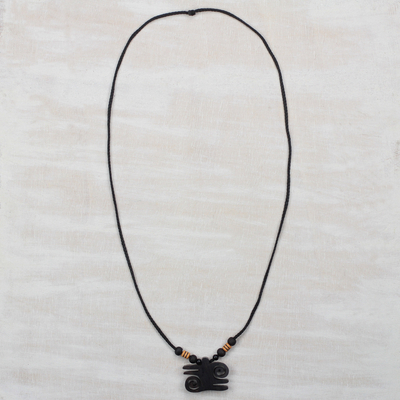 Ebony wood pendant necklace, 'Kwatakye Atiko Curls' - Ebony Wood and Recycled Plastic Adinkra Necklace from Ghana
