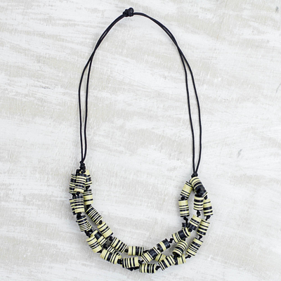 Recycled plastic beaded necklace, 'Live with Praise' - Recycled Plastic Disc Black and Yellow Statement Necklace