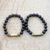Recycled glass bead stretch bracelets, 'Ebony Duo' (pair) - Black and Gold Recycled Bead Stretch Bracelets (Pair) thumbail