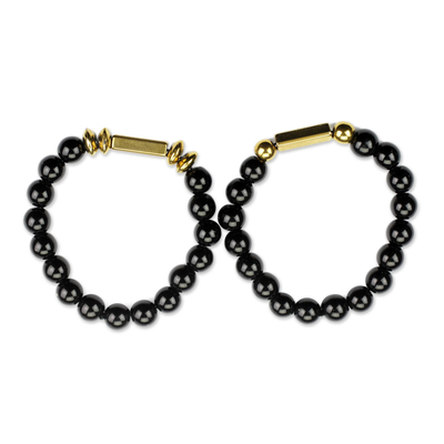 Recycled glass bead stretch bracelets, 'Ebony Duo' (pair) - Black and Gold Recycled Bead Stretch Bracelets (Pair)