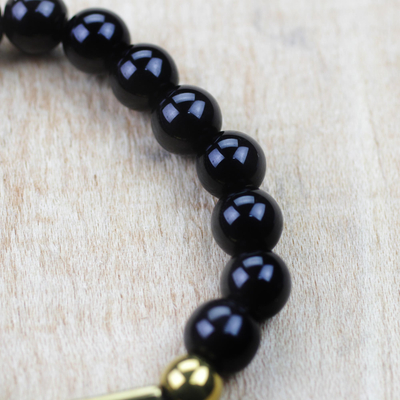Recycled glass bead stretch bracelets, 'Ebony Duo' (pair) - Black and Gold Recycled Bead Stretch Bracelets (Pair)