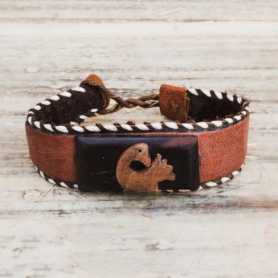 Ebony wood and leather cuff bracelet, 'Charming Sankofa' - Ebony Wood and Leather Adinkra Cuff Bracelet from Ghana