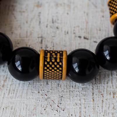 Recycled plastic bead stretch bracelet, 'Madanfo' - Bold Black and Yellow Recycled Bead Stretch Bracelet