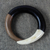 Ebony and bone bangle bracelet, 'Bold Curve' - Hand Carved Ebony Wood and Cow Bone Bangle Bracelet