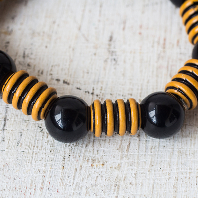 Recycled plastic bead stretch bracelet, 'Modern Buzz' - Bold Black and Yellow Striped Recycled Bead Stretch Bracelet