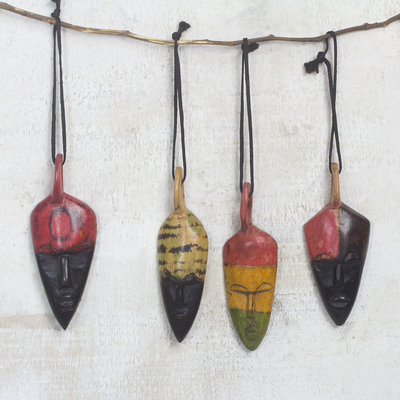 Wood ornaments, 'Colorful Masks' (set of 4) - African Mask-Themed Wood Ornaments from Ghana (Set of 4)