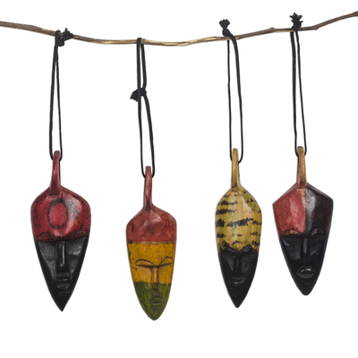 Wood ornaments, 'Colorful Masks' (set of 4) - African Mask-Themed Wood Ornaments from Ghana (Set of 4)
