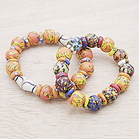 Glass beaded stretch bracelets, 'Goldenrod Maidens' (Pair) - Eco-Friendly Recycled Glass Beaded Stretch Bracelets (Pair)