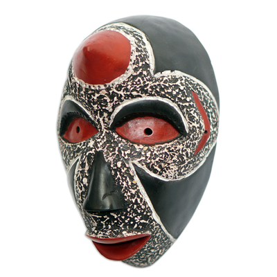 Afrikanische Holzmaske - Handgefertigte afrikanische Sese-Holzmaske in Schwarz- und Rottönen