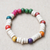 Wood beaded stretch bracelet, 'Joyful People' - Handcrafted colourful Sese Wood Beaded Stretch Bracelet