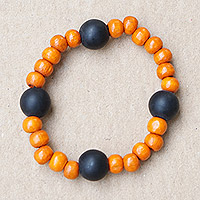 Recycled glass and wood beaded stretch bracelet, 'Orange Success' - Recycled Glass and Sese Wood Beaded Bracelet in Orange