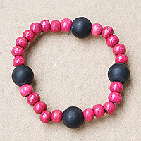 Recycled glass and wood beaded stretch bracelet, 'Fuchsia Success' - Recycled Glass and Sese Wood Beaded Bracelet in Fuchsia