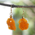 Recycled glass beaded dangle earrings, 'Afia's Orange Knot' - Eco-Friendly Orange Glass Beaded Dangle Earrings from Ghana