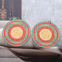 Raffia wall art, 'Ghanaian Suns' (pair) - Pair of Round Turquoise and Fuchsia Raffia Wall Accents