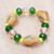 Recycled glass beaded stretch bracelet, 'Harmonious Friend' - Green and Yellow Recycled Glass Beaded Stretch Bracelet