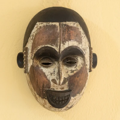 African wood wall mask, 'The Okuyi Joy' - Okuyi Ritual-Inspired Sese Wood Mask with Ceramic Accents