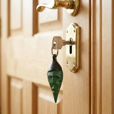 Wood keychain, 'Emerald Visage' - Emerald Green Sese Wood Mask Keychain with Metallic Ring