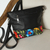 Cotton accent leather shoulder bag, 'Sophisticated Bouquet' - Embroidered Cotton Accent Black Leather Sling from Mexico