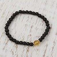 Gold accented amber and onyx beaded stretch bracelet, 'Ancient Depth' - Amber and Onyx Beaded Stretch Bracelet with 14k Gold Accents