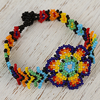Glass beaded wristband bracelet, 'Colorful Huichol Flower' - Floral Glass Beaded Wristband Necklace from Mexico
