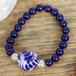 Ceramic and lapis lazuli pendant stretch bracelet, 'Cobalt Flourish' - Lapis Lazuli and Ceramic Bead Pendant Bracelet