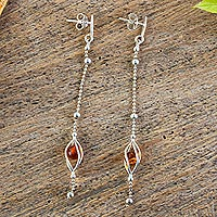 Amber dangle earrings, 'Fantasy Glow' - Sterling Silver Dangle Earrings Encasing Amber Beads