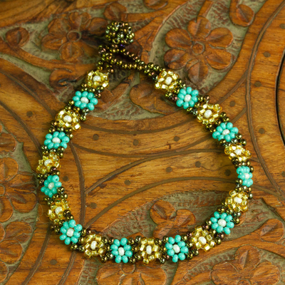 Glass beaded bracelet, 'Turquoise Sparks' - Handcrafted Glass Beaded Bracelet with Floral Motifs