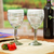 Handblown wine glasses, 'Luxury Spiral' (pair) - Pair of White Handblown Wine Glasses with Spiral Motifs