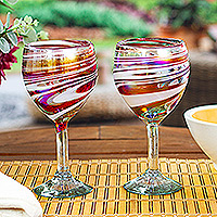 Handblown wine glasses, 'Splendid Enchantment' (pair) - Pair of Eco-Friendly Red and White Handblown Wine Glasses