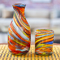 Handblown recycled glass carafe and glass set, 'Whirling Colors' (pair) - Set of Handblown Recycled Glass Carafe with Matching Cup