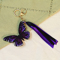 Wood keychain and bag charm, 'Monarchs of Hope' - Hand-Painted Wood Butterfly Keychain and Bag Charm in Purple
